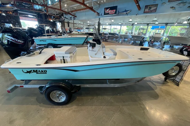 The Image of 2026 Mako Pro Skiff 15 CC boat displayed in a showroom, featuring a sleek design. - 0