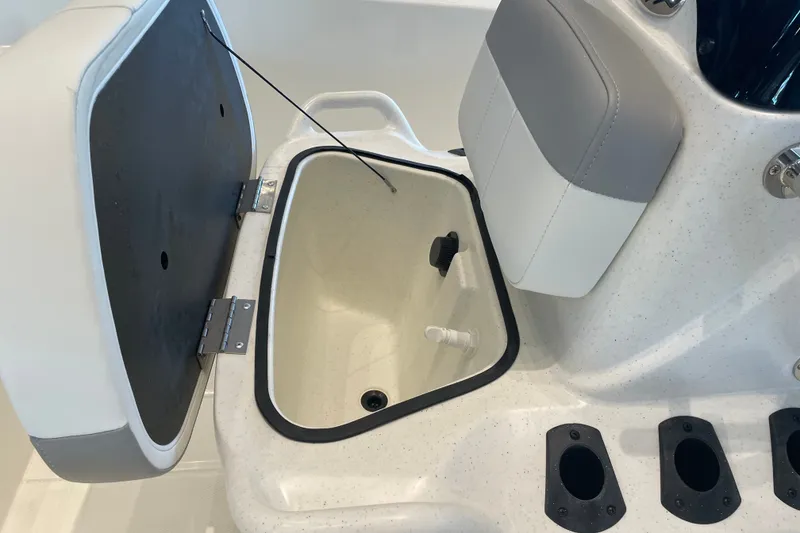 Slide: The Image of 2026 Mako Pro Skiff 15 CC boat storage compartment with open lid and seating. - 4