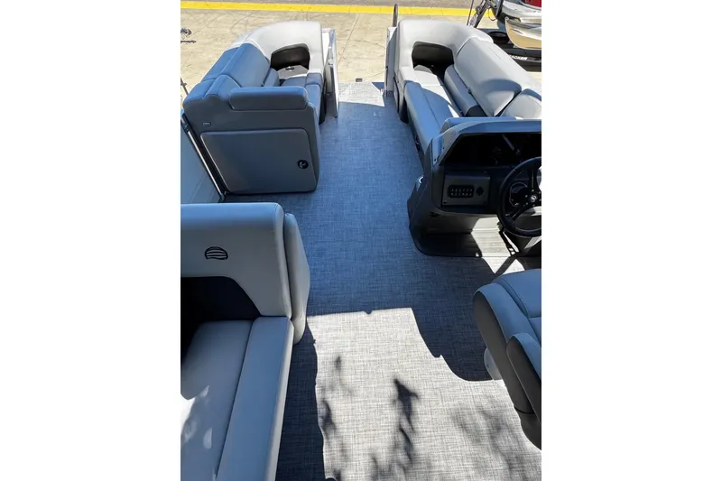 Slide: The Image of 2026 Sun Tracker Party Barge 20 DLX interior with gray seating and spacious layout. - 13