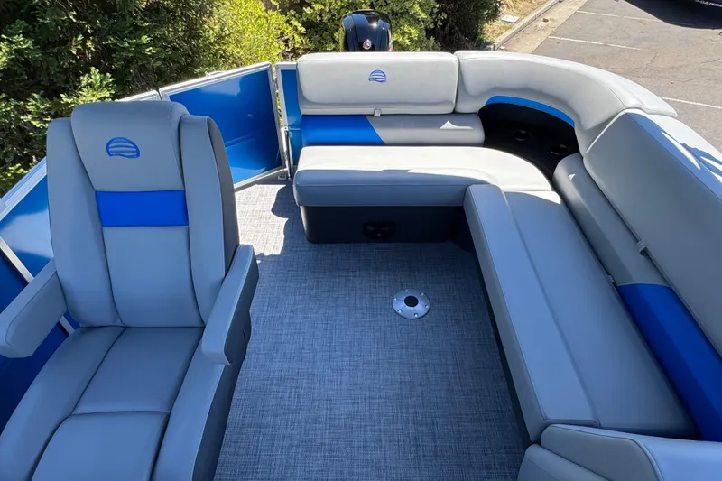 Slide: The Image of 2026 Sun Tracker Party Barge 20 DLX interior with gray and blue seating. - 16