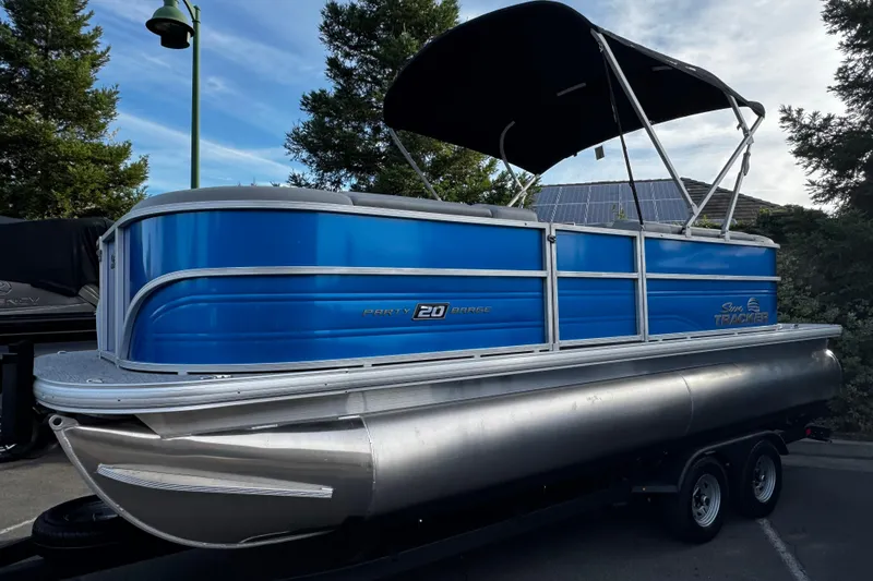 Slide: The Image of 2026 Sun Tracker Party Barge 20 DLX pontoon boat with blue exterior and canopy. - 7