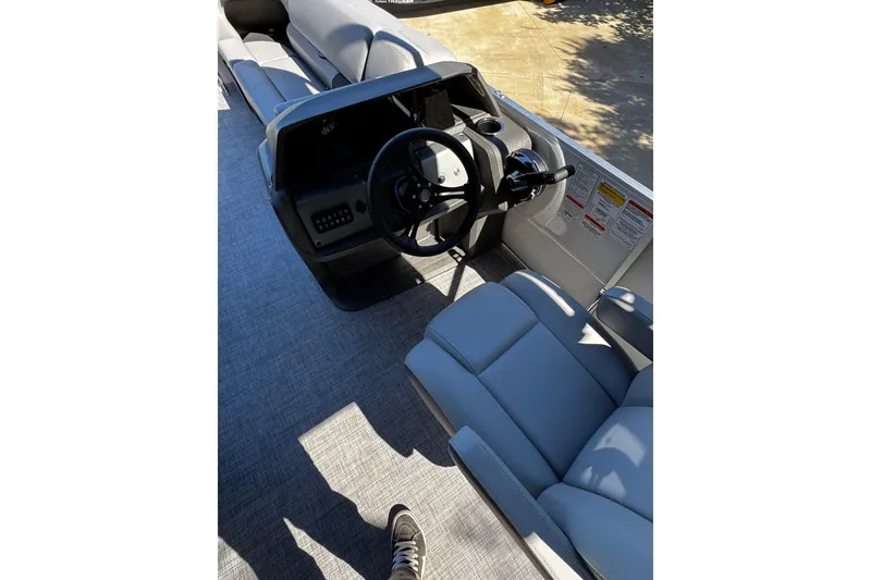 Slide: The Image of Interior view of 2026 Sun Tracker Party Barge 20 DLX pontoon boat cockpit. - 15
