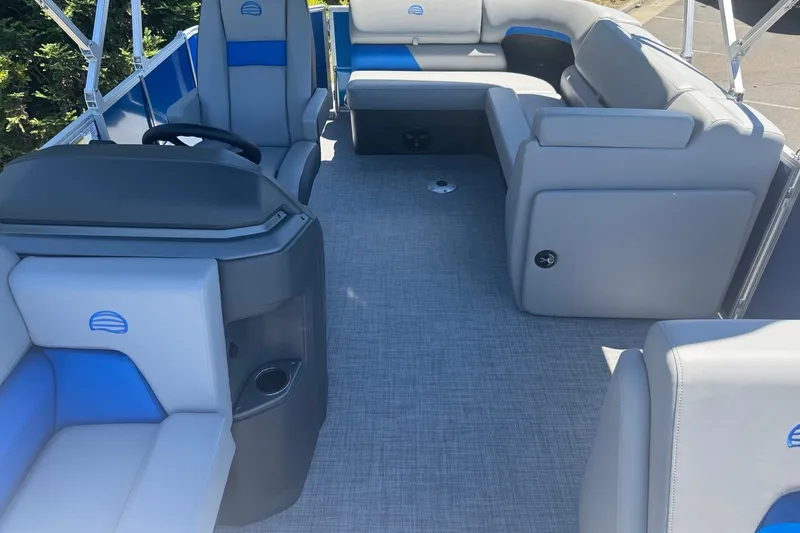 Slide: The Image of 2026 Sun Tracker Party Barge 20 DLX interior with gray and blue seating. - 14