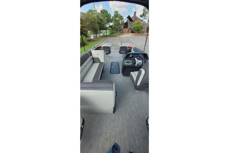 Slide: The Image of 2026 Sun Tracker Fishin' Barge 22 XP3 interior with seating and steering console. - 5
