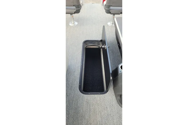 Slide: The Image of Open storage compartment on 2026 Sun Tracker Fishin' Barge 22 XP3 boat. - 6