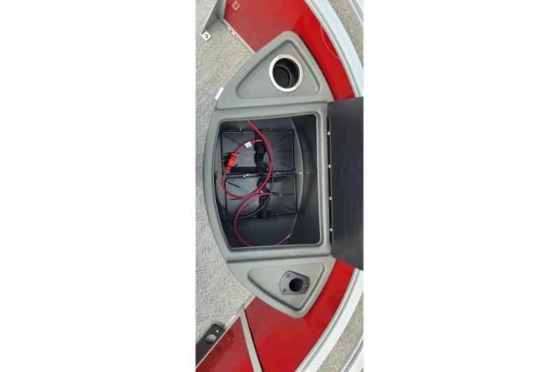 Slide: The Image of 2026 Sun Tracker Fishin' Barge 22 XP3 battery compartment with wiring and cup holder. - 7