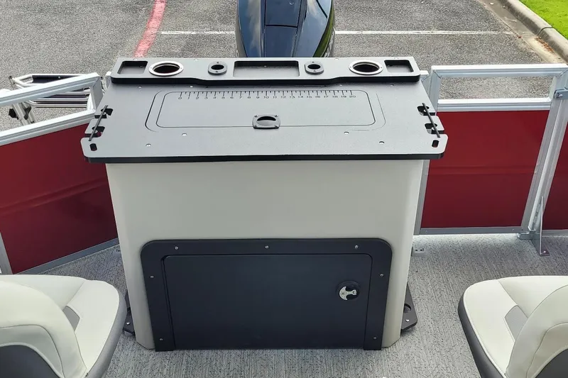 Slide: The Image of 2026 Sun Tracker Fishin' Barge 22 XP3 console with cup holders and storage compartment. - 3