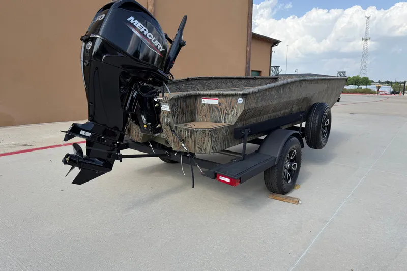 Slide: The Image of 2026 Tracker Grizzly 1650 T Prairie Wings Edition boat with Mercury engine on trailer. - 13