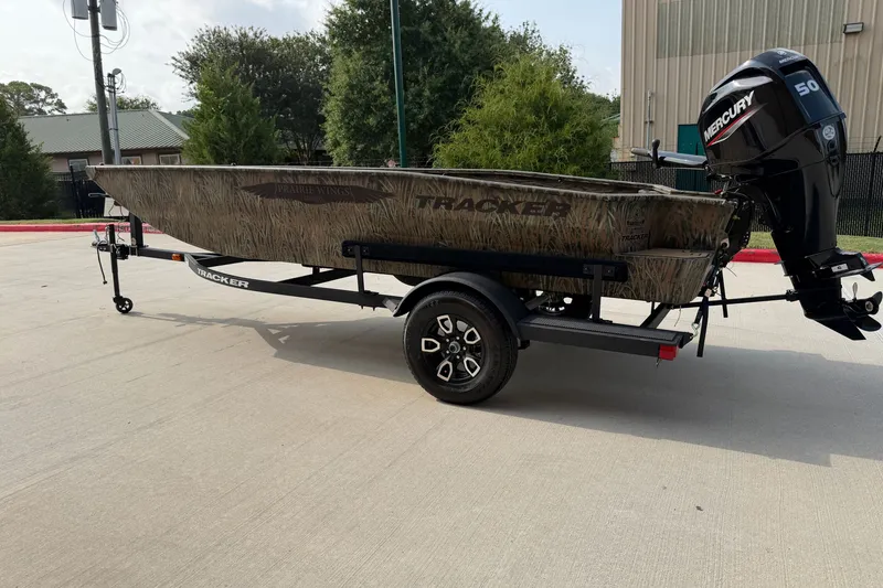 The Image of 2026 Tracker Grizzly 1650 T Prairie Wings Edition boat with Mercury engine on trailer. - 0