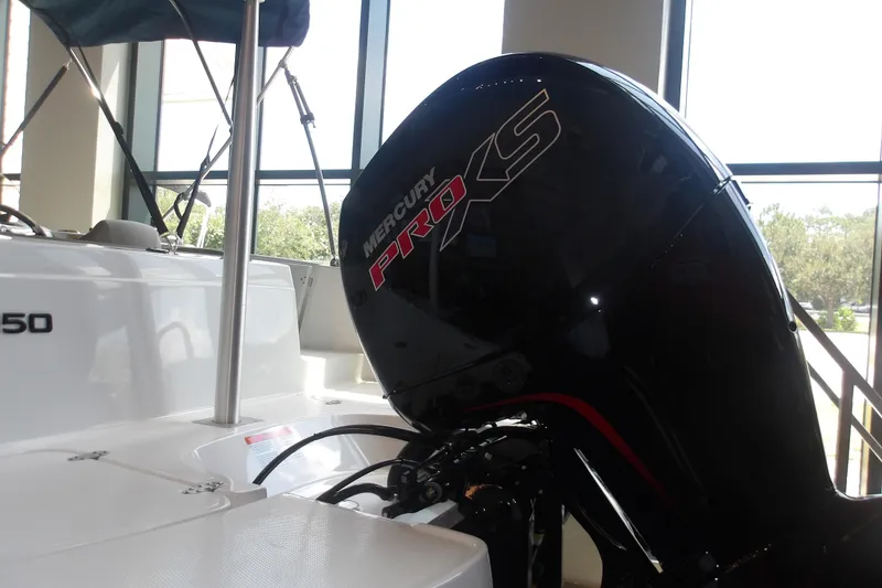 Slide: The Image of 2026 Tahoe 2150 boat with Mercury Pro XS engine in showroom. - 9