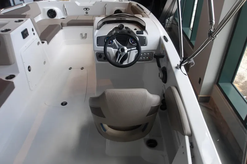 Slide: The Image of Interior view of 2026 Tahoe 2150 boat, featuring steering wheel and seating area. - 15