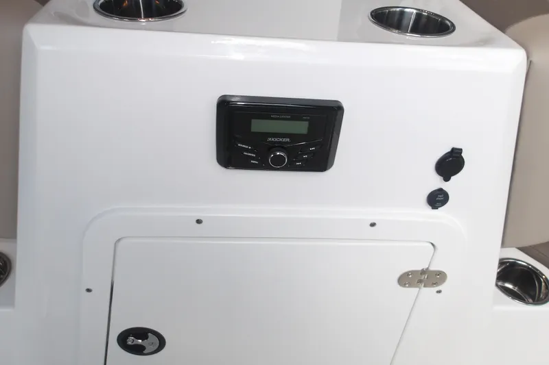 Slide: The Image of 2026 Tahoe 2150 boat console with stereo system and storage compartment. - 26