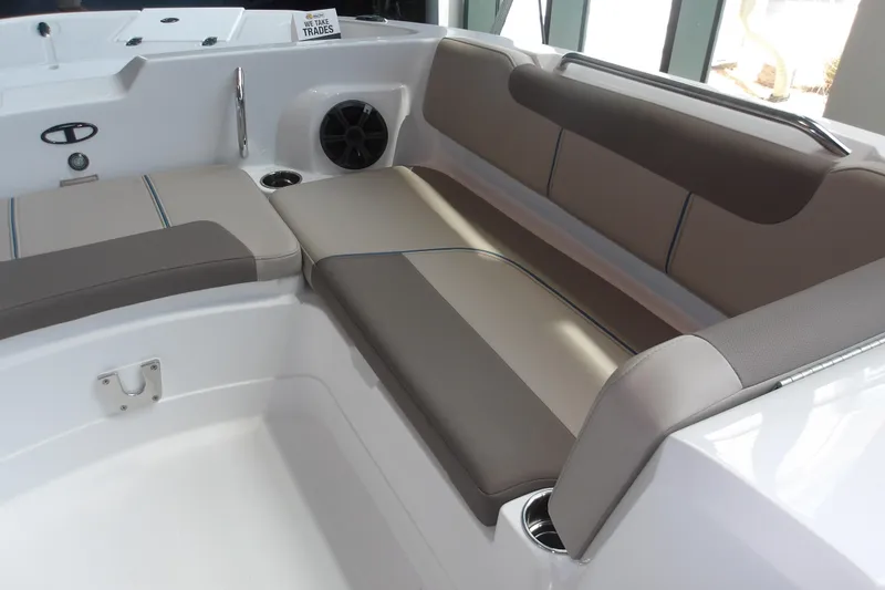 Slide: The Image of 2026 Tahoe 2150 boat interior with cushioned seating and cup holders. - 23