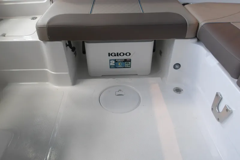 Slide: The Image of Interior of 2026 Tahoe 2150 boat featuring Igloo cooler storage under seating. - 20