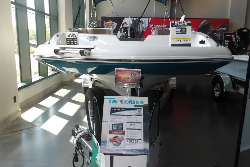 Slide: The Image of 2026 Tahoe 2150 boat displayed indoors with promotional signage and financing options. - 3