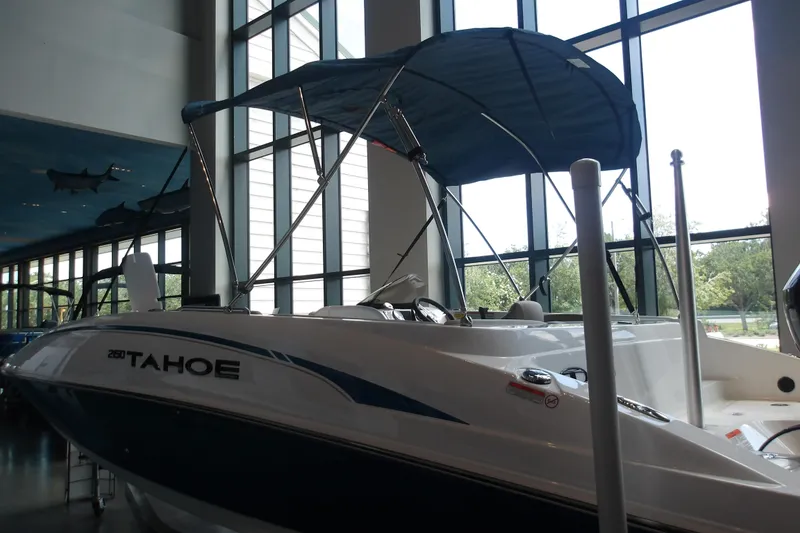 Slide: The Image of 2026 Tahoe 2150 boat displayed indoors with canopy and modern design. - 27