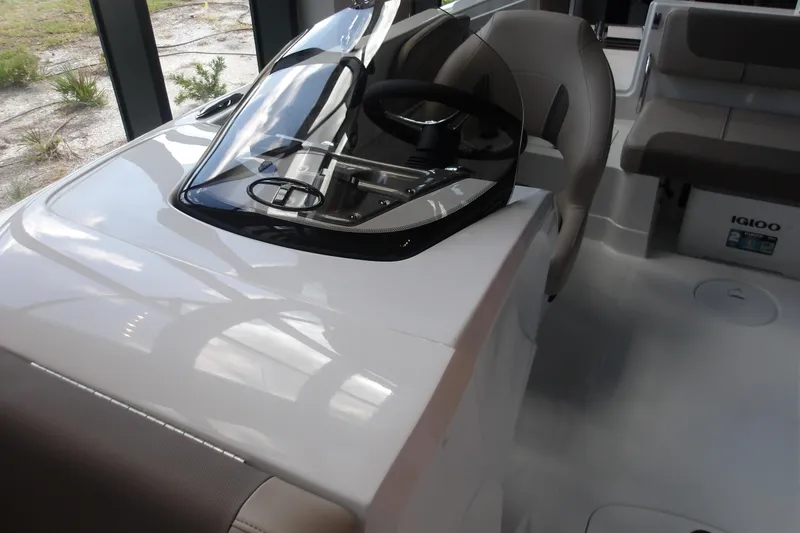 Slide: The Image of 2026 Tahoe 2150 boat interior with sleek steering console and comfortable seating. - 18