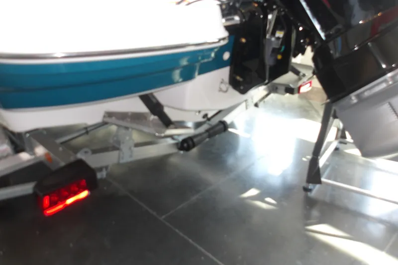 Slide: The Image of 2026 Tahoe 2150 boat on trailer, featuring sleek design and modern outboard motor. - 8