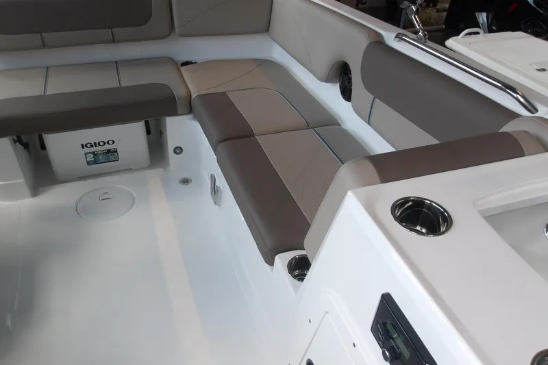 Slide: The Image of 2026 Tahoe 2150 boat interior with cushioned seating and built-in Igloo cooler. - 17