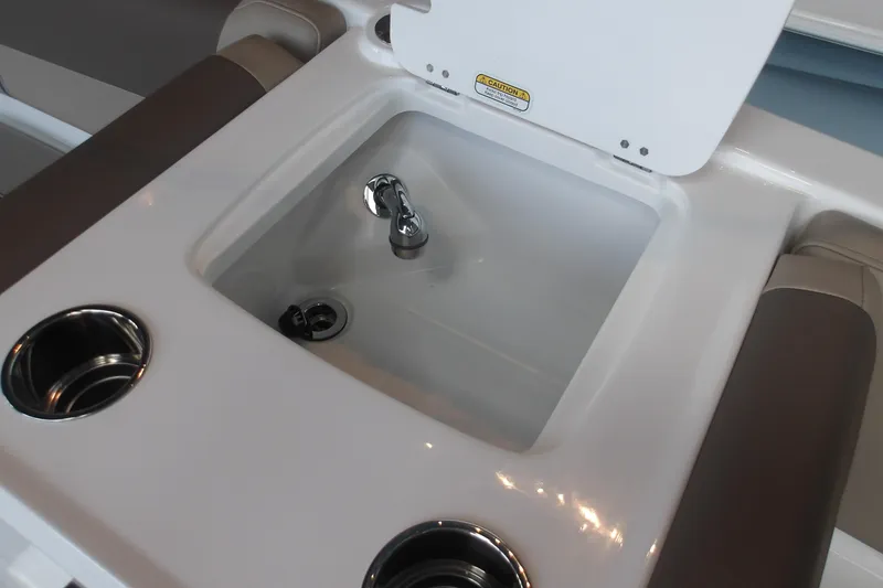 Slide: The Image of 2026 Tahoe 2150 boat sink with cup holders and cushioned seating. - 16