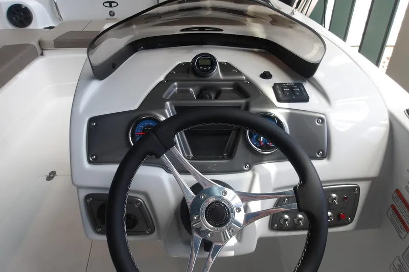 Slide: The Image of Steering console of a 2026 Tahoe 2150 boat with gauges and controls. - 21