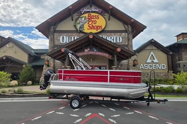 The Image of 2026 Sun Tracker Party Barge 18 DLX pontoon boat outside Bass Pro Shops. - 0