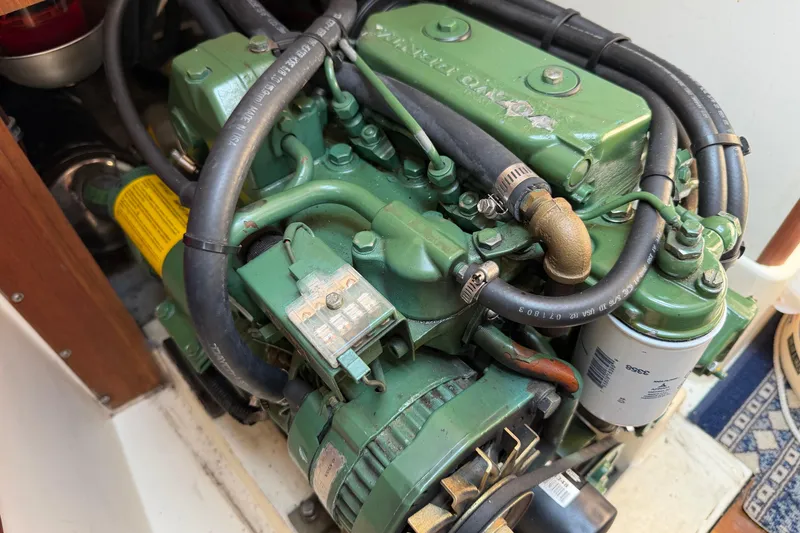 Slide: The Image of Engine of a 1991 Tartan 28 Piper sailboat, featuring green components and hoses. - 23