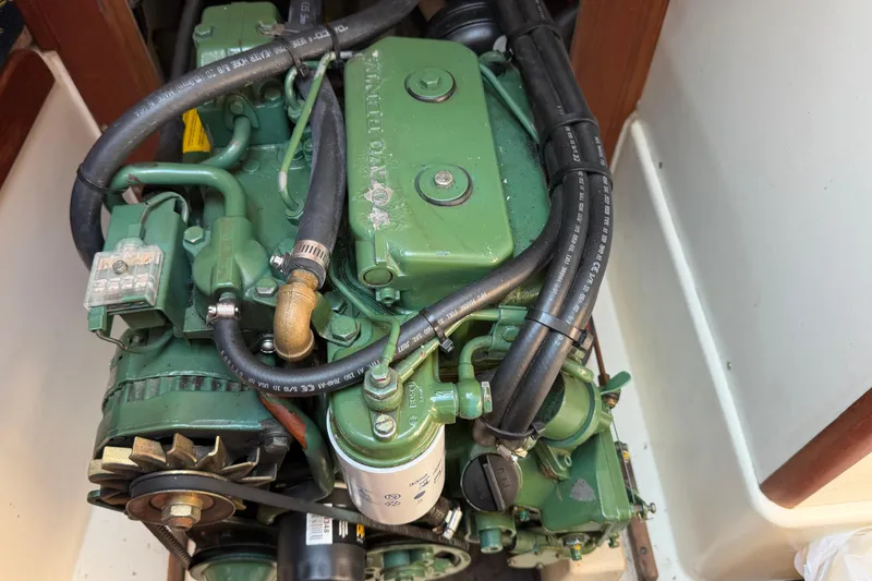 Slide: The Image of Engine of a 1991 Tartan 28 Piper sailboat, featuring green components and hoses. - 24