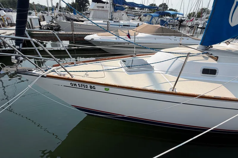 Slide: The Image of 1991 Tartan 28 Piper sailboat docked in a marina, displaying registration number OH 5752 BG. - 2