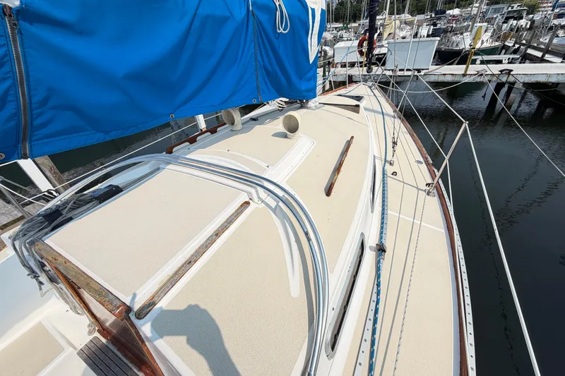 Slide: The Image of 1991 Tartan 28 Piper sailboat with blue sail cover, docked at marina. - 5