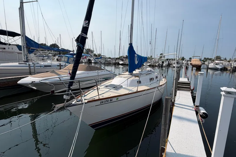 The Image of Sailboat docked at marina, Tartan 28 Piper, 1991 model, calm waters, clear sky. - 0