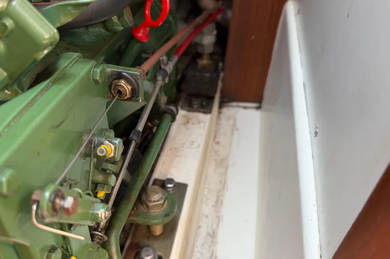 Slide: The Image of Engine compartment of a 1991 Tartan 28 Piper sailboat, showcasing mechanical components. - 25