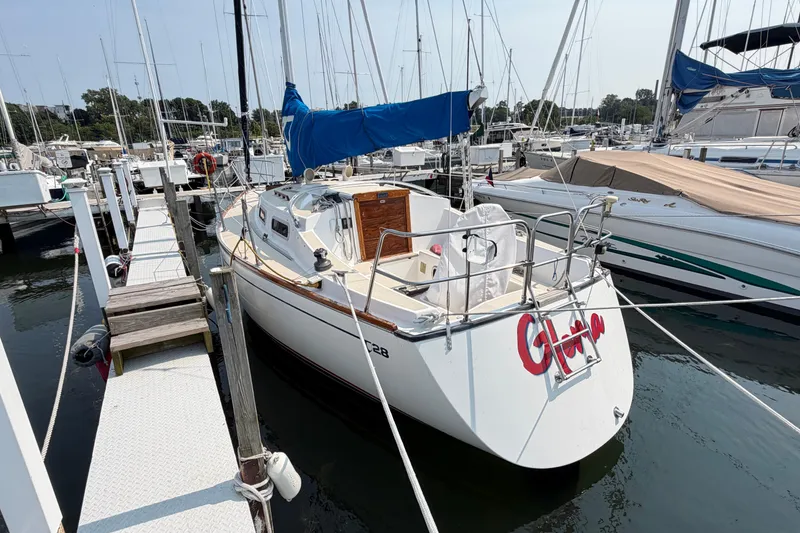 Slide: The Image of Sailboat docked at marina, Tartan 28 Piper, 1991 model, with blue sail cover. - 6
