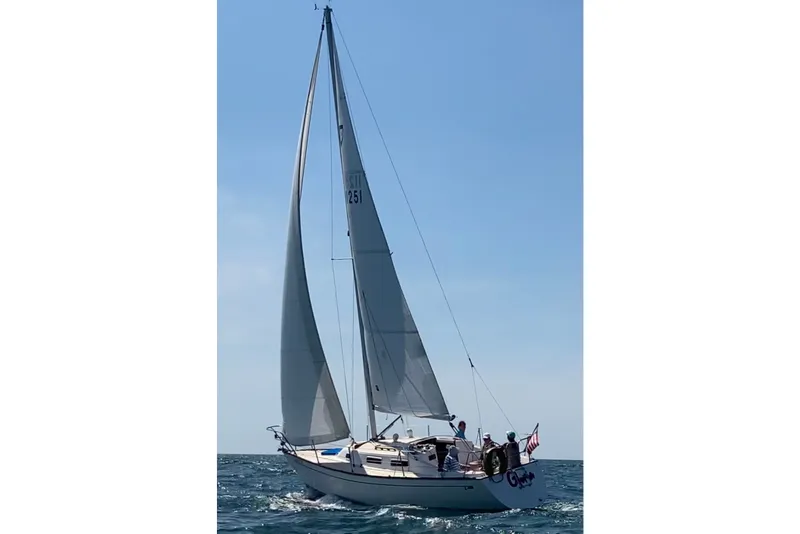 Slide: The Image of Sailing yacht Tartan 28 Piper 1991 on open sea with crew onboard. - 28