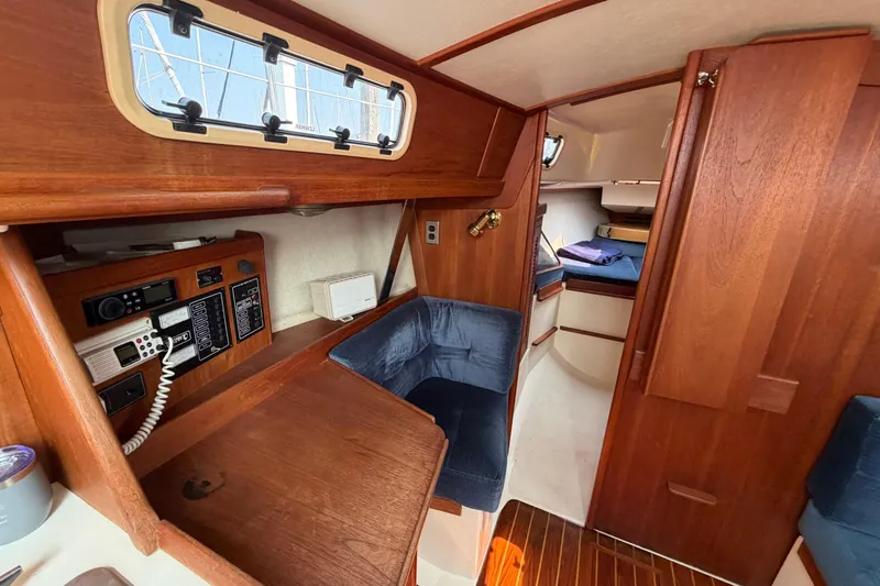 Slide: The Image of Interior of 1991 Tartan 28 Piper sailboat with wood finish and navigation equipment. - 16