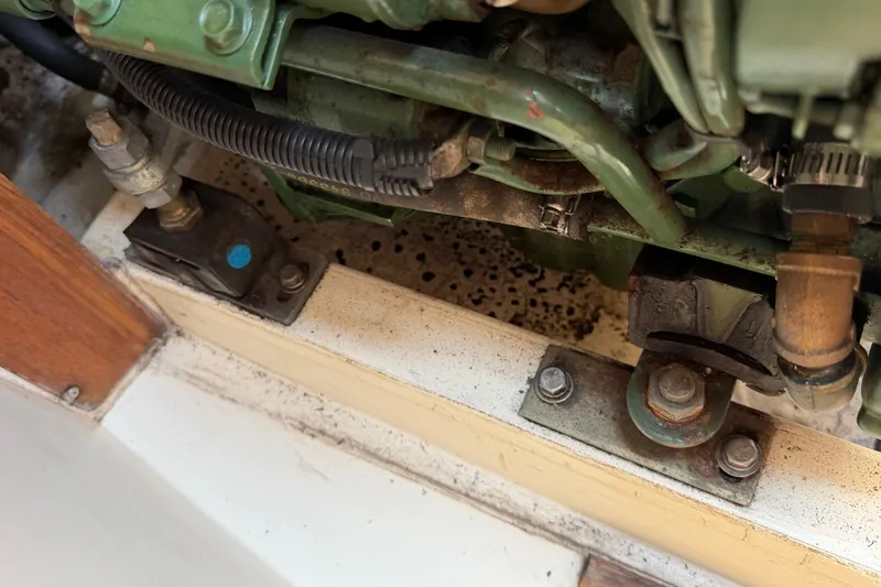 Slide: The Image of Engine compartment of a 1991 Tartan 28 Piper sailboat, showing mechanical components and fittings. - 26