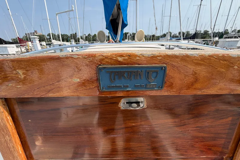 Slide: The Image of Wooden deck of a 1991 Tartan 28 Piper sailboat with nameplate. - 27