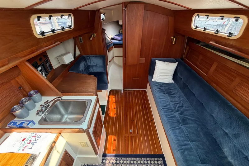 Slide: The Image of Interior of 1991 Tartan 28 Piper sailboat with wood finish and blue upholstery. - 10