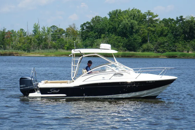 Slide: The Image of 2011 Scout 225 Abaco boat cruising on a calm river with lush green shoreline. - 1