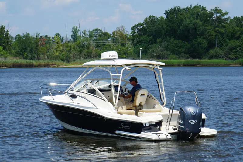 Slide: The Image of 2011 Scout 225 Abaco boat cruising on a calm river with lush green shoreline. - 3