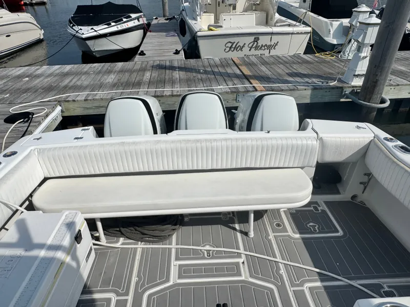 Slide: The Image of The image shows the cockpit of a 2002 Intrepid 377 Walkaround with three engines at the dock. - 10