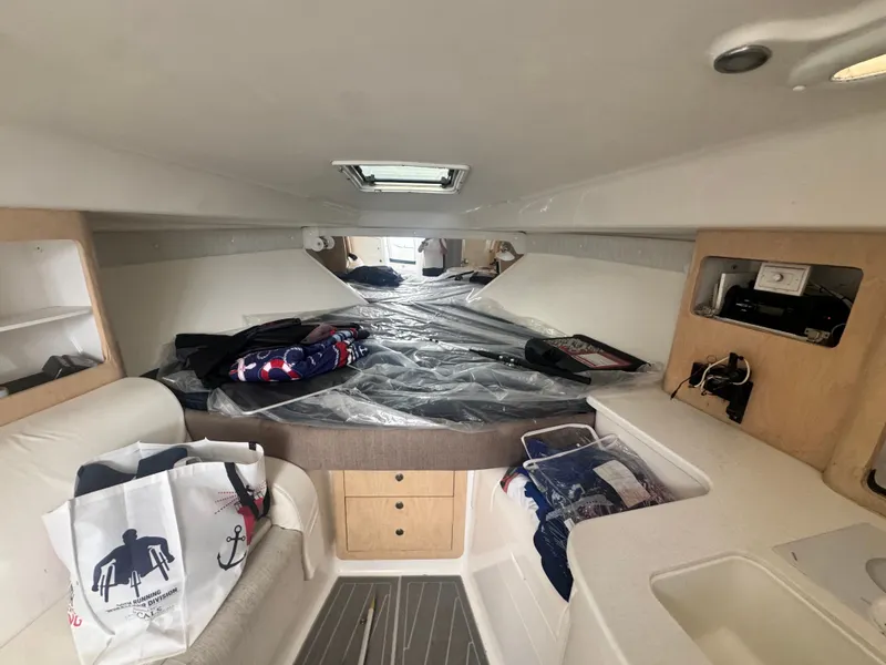 Slide: The Image of Interior of a 2002 Intrepid 377 Walkaround featuring a sleeping area and storage. - 15