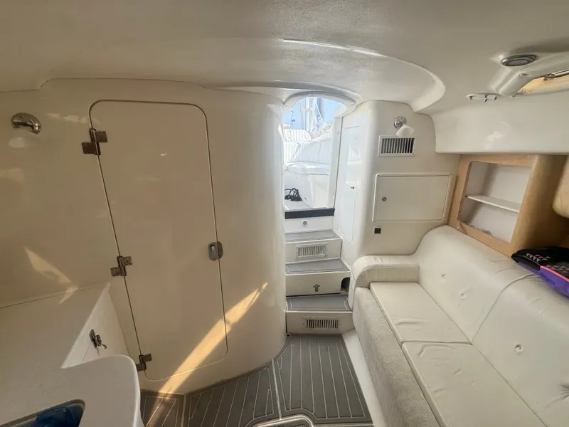 Slide: The Image of Interior of a 2002 Intrepid 377 Walkaround with white sofa and storage space. - 14