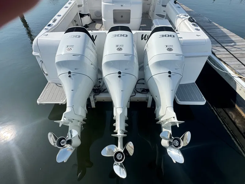 Slide: The Image of Three powerful outboard engines are mounted on the stern of an Intrepid 377 Walkaround boat. - 5
