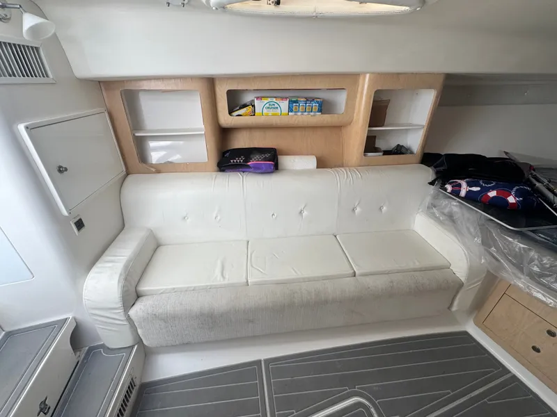 Slide: The Image of Interior of a 2002 Intrepid 377 Walkaround with a white sofa and shelving. - 13