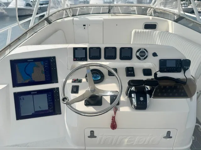 Slide: The Image of The image shows the helm of a 2002 Intrepid 377 Walkaround with various instruments and screens. - 6