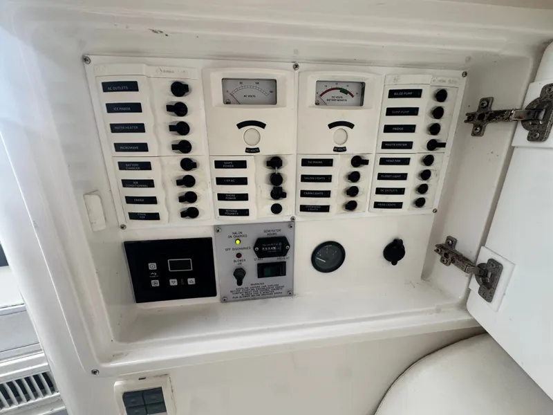 Slide: The Image of An electrical control panel on a boat with various switches and gauges. - 17
