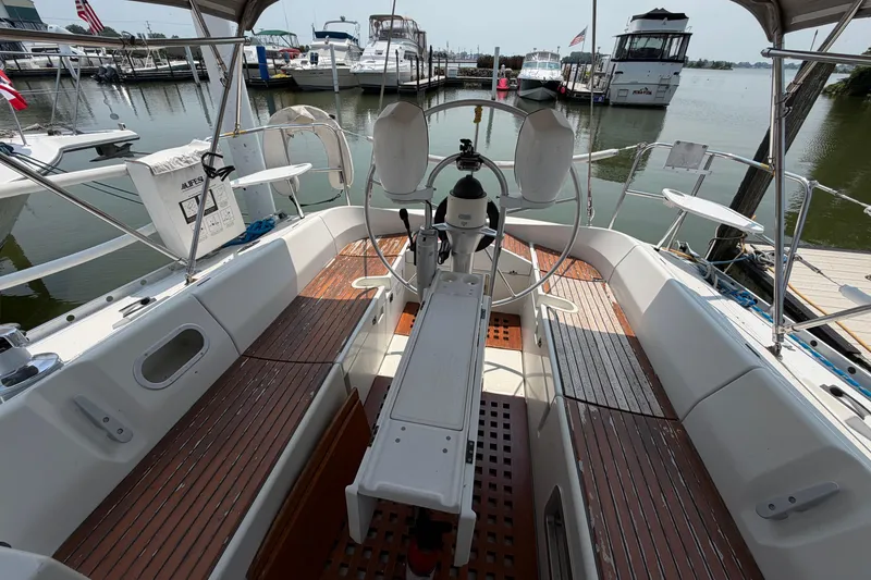Slide: The Image of Cockpit of a 1988 Beneteau Oceanis 390 sailboat docked at a marina. - 9
