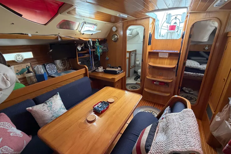 Slide: The Image of Cozy interior of 1988 Beneteau Oceanis 390 sailboat with wooden furnishings and seating area. - 28