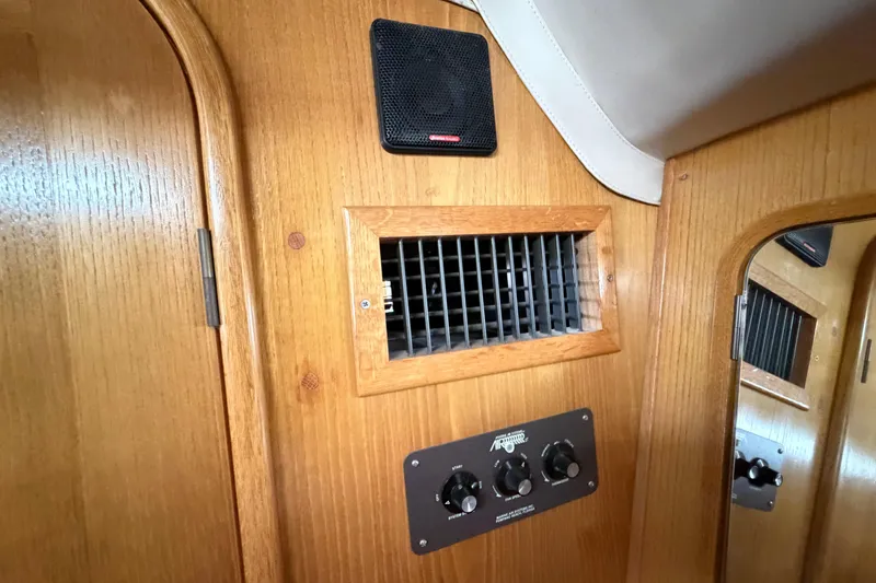 Slide: The Image of Interior of 1988 Beneteau Oceanis 390 yacht showing wooden paneling and ventilation controls. - 33